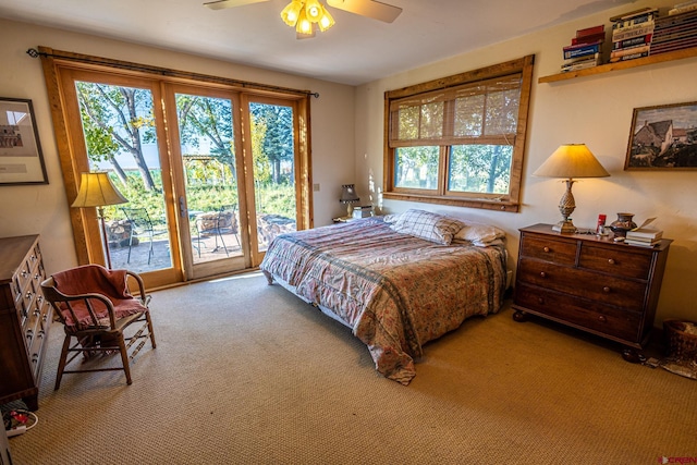 carpeted bedroom with ceiling fan and access to exterior