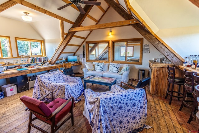 interior space with lofted ceiling with beams, ceiling fan, and dark wood-type flooring