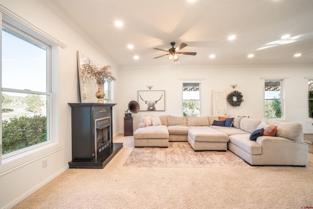 living room featuring ornamental molding, light carpet, and plenty of natural light