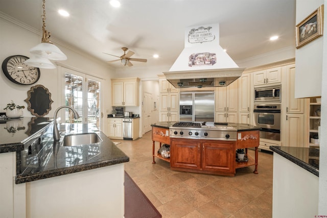 kitchen with ornamental molding, sink, custom exhaust hood, hanging light fixtures, and built in appliances