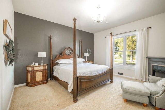 bedroom featuring a notable chandelier and carpet floors