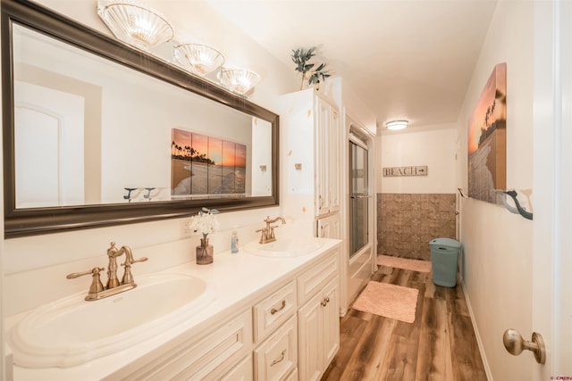 bathroom featuring walk in shower, hardwood / wood-style floors, and vanity