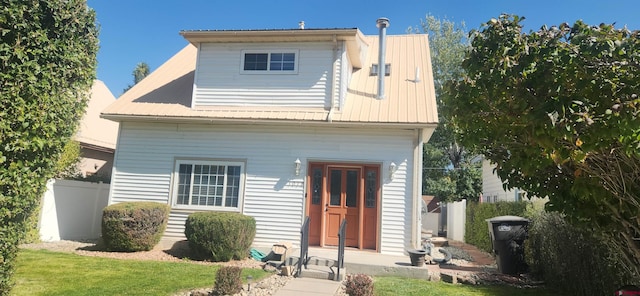 rear view of house with a lawn