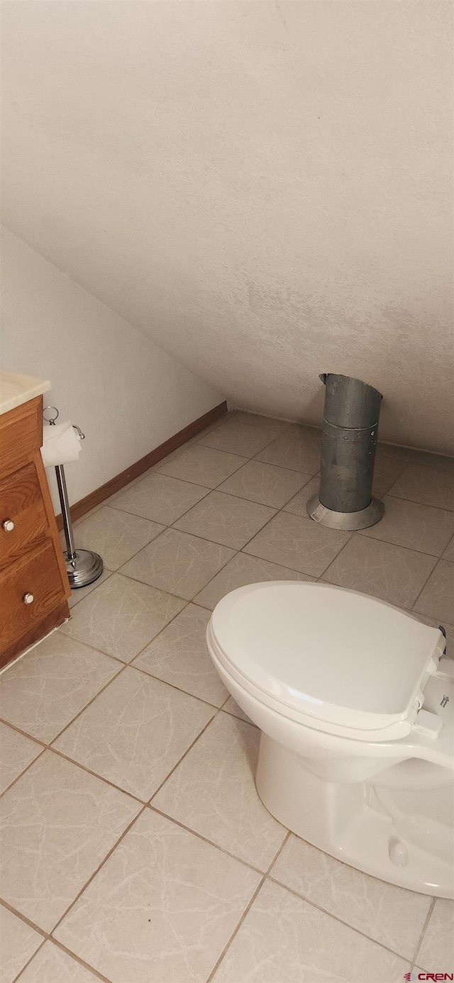 bathroom featuring vanity, toilet, and tile patterned floors