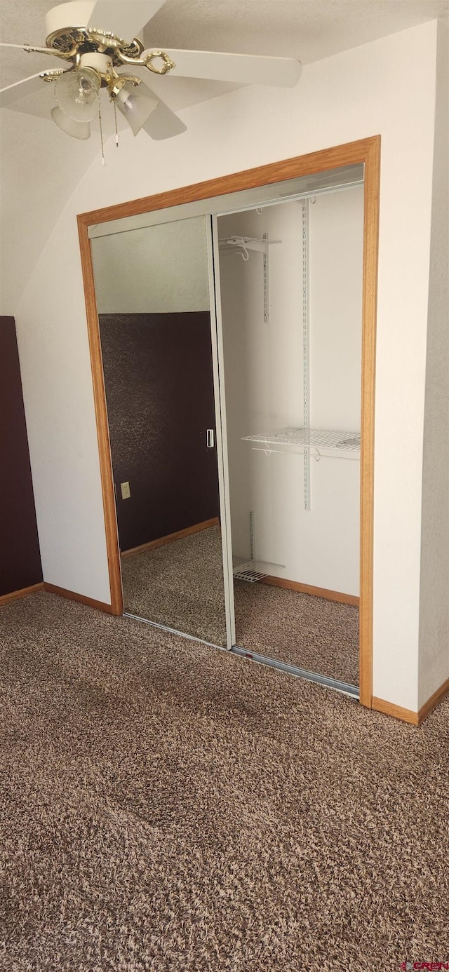 unfurnished bedroom with a closet, carpet, and ceiling fan