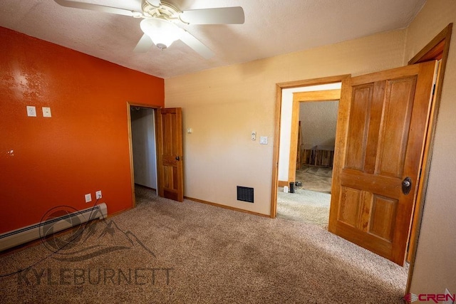 unfurnished bedroom featuring ceiling fan, carpet flooring, and a baseboard heating unit