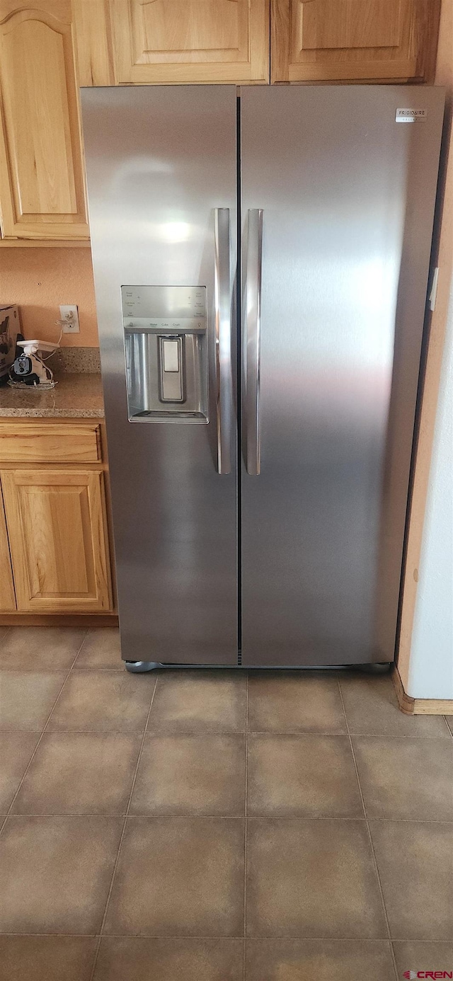 kitchen with stainless steel fridge with ice dispenser and light brown cabinets