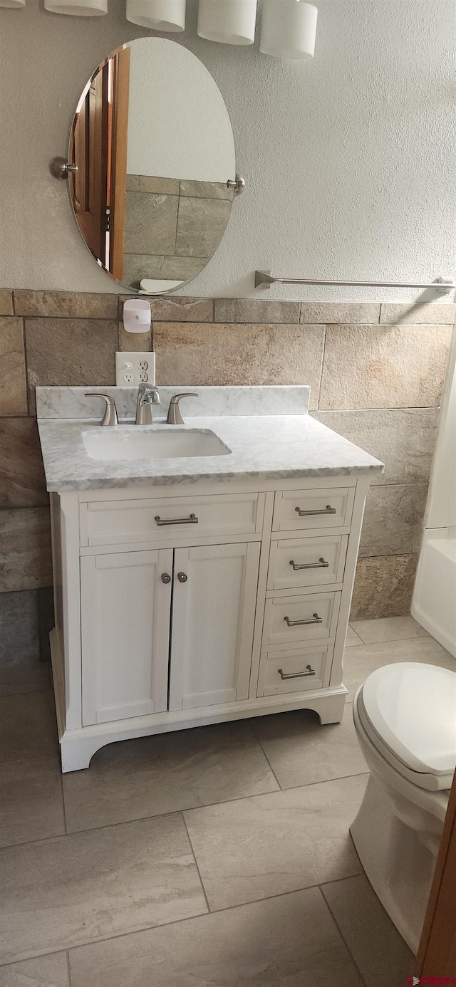 bathroom with vanity, toilet, and tile patterned floors