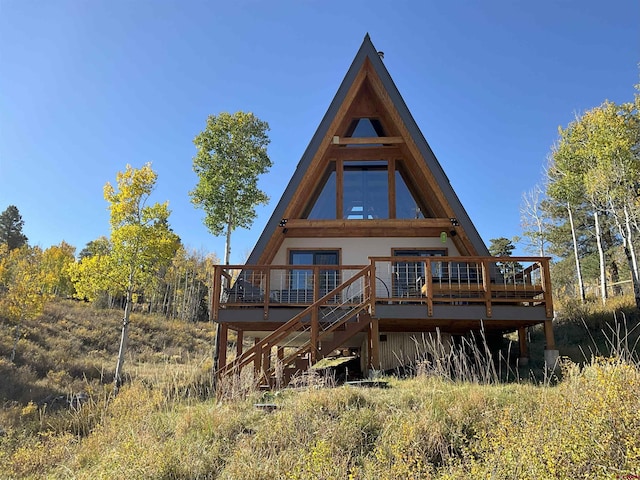 rear view of house with a wooden deck