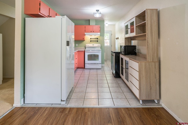 kitchen with light hardwood / wood-style flooring and white appliances