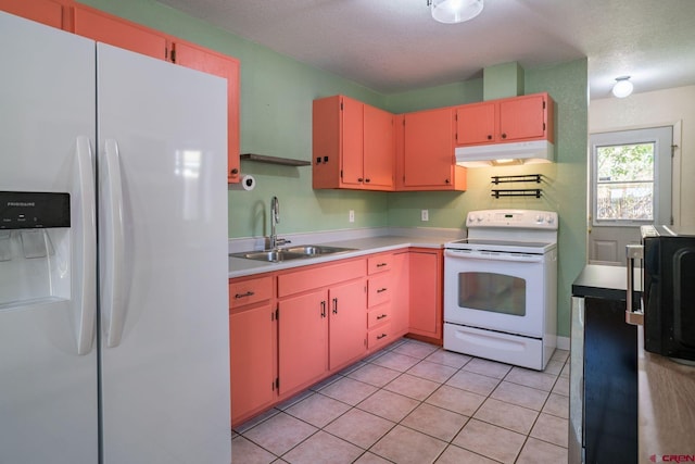 kitchen with white appliances, sink, light tile patterned floors, and a textured ceiling