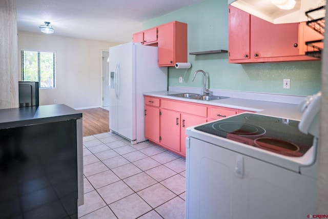 kitchen featuring white appliances, sink, and light tile patterned floors