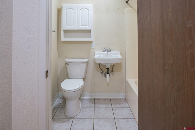 bathroom featuring sink, toilet, and tile patterned floors