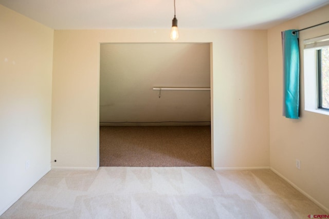 empty room featuring light carpet