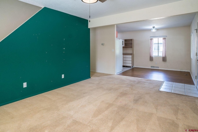 unfurnished living room featuring hardwood / wood-style floors and a textured ceiling