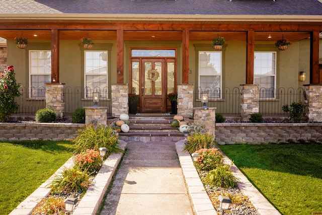 view of exterior entry with a porch