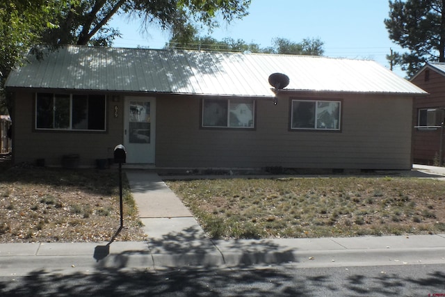 ranch-style home with metal roof