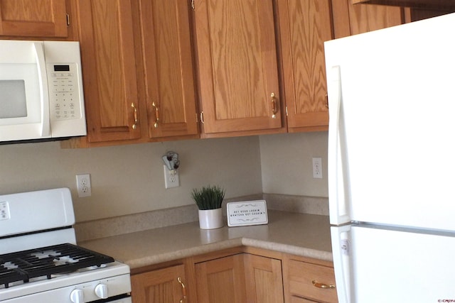 kitchen featuring white appliances and light countertops