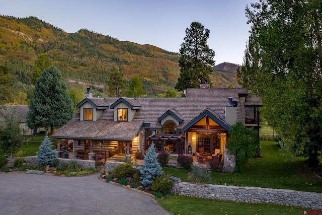 log home with a front yard and a mountain view