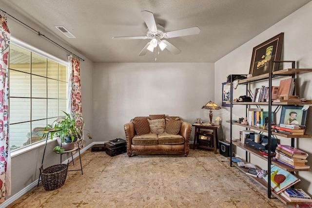 living area featuring ceiling fan and light colored carpet