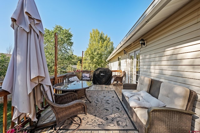 view of patio with a wooden deck and a grill