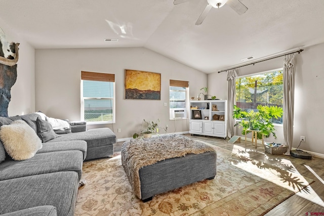 living room with light hardwood / wood-style floors, lofted ceiling, cooling unit, and ceiling fan