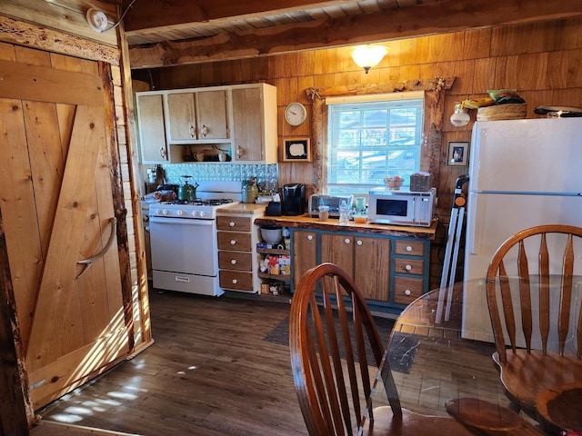 kitchen with beamed ceiling, wood ceiling, white appliances, dark hardwood / wood-style flooring, and wood walls