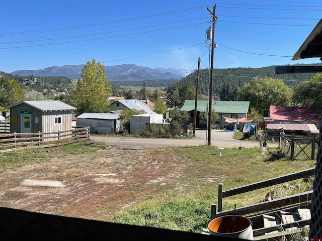 view of yard with a storage unit and a mountain view