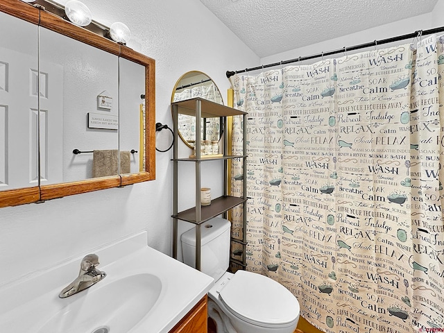 bathroom with vanity, a textured ceiling, and toilet