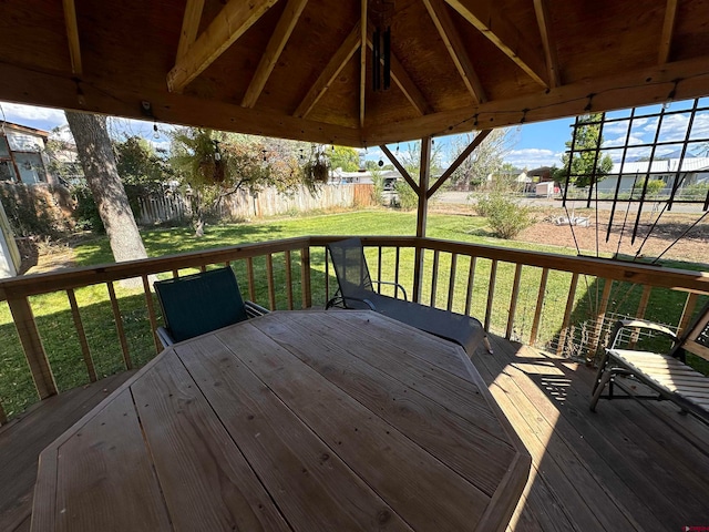 wooden terrace with a gazebo and a lawn