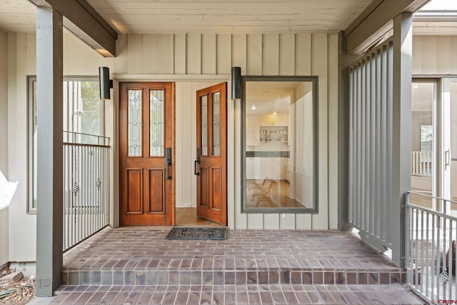 view of exterior entry with a porch