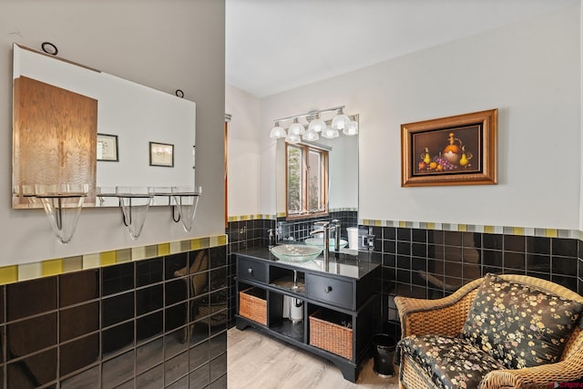 bathroom featuring sink, tile walls, and hardwood / wood-style floors