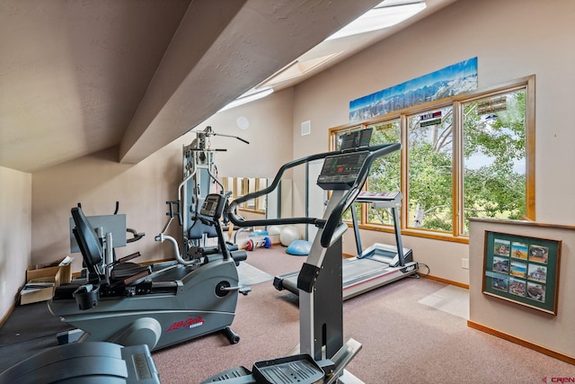 workout area featuring light colored carpet and vaulted ceiling