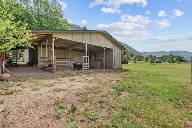 rear view of house featuring a mountain view and an outbuilding