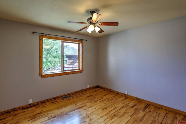 unfurnished room with ceiling fan and light hardwood / wood-style floors