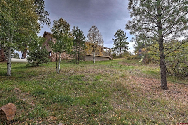 view of yard featuring a wooden deck