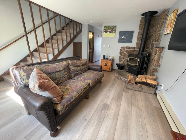 living room featuring light hardwood / wood-style flooring and a wood stove