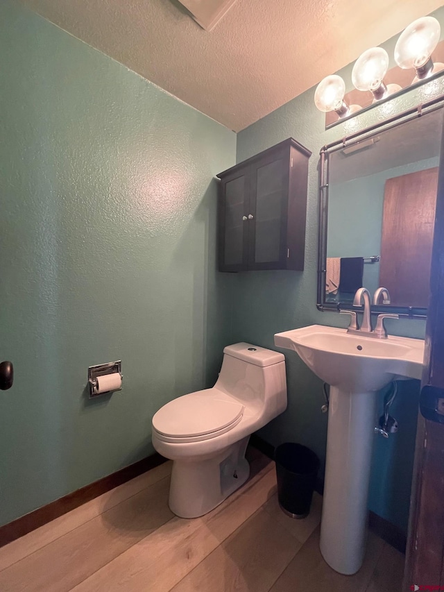 bathroom featuring toilet and wood-type flooring