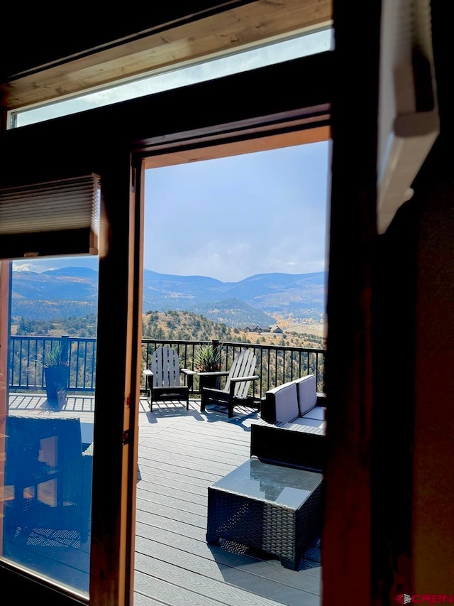 doorway featuring plenty of natural light, hardwood / wood-style floors, and a mountain view