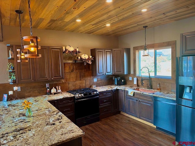 kitchen featuring decorative backsplash, dark wood-type flooring, light stone counters, stainless steel appliances, and hanging light fixtures