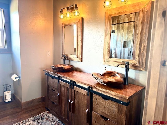 bathroom with hardwood / wood-style floors and vanity