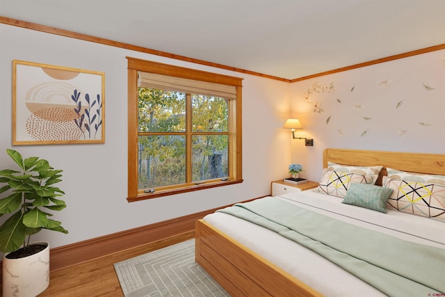 bedroom featuring crown molding and light hardwood / wood-style floors