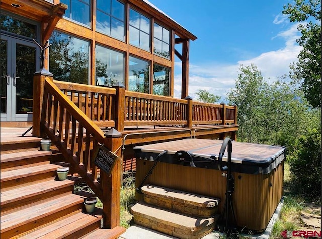 wooden terrace with a hot tub