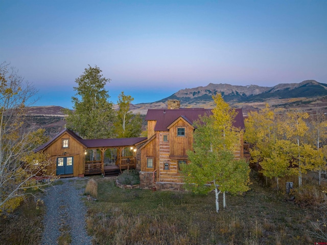 view of front of home featuring a deck with mountain view