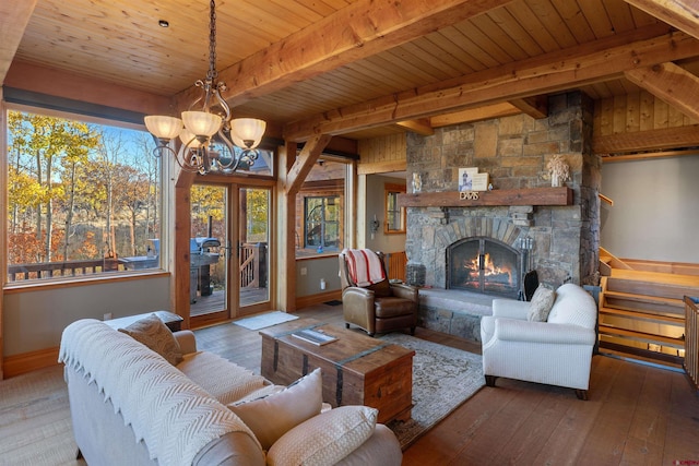 living room featuring a stone fireplace, hardwood / wood-style flooring, wood ceiling, and beamed ceiling