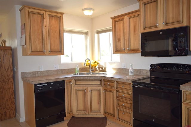 kitchen with light tile patterned flooring, black appliances, and sink