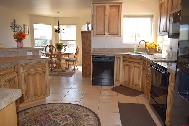 kitchen with black appliances, sink, light tile patterned floors, and a healthy amount of sunlight