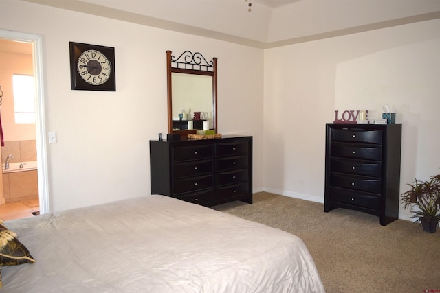 carpeted bedroom with ensuite bath