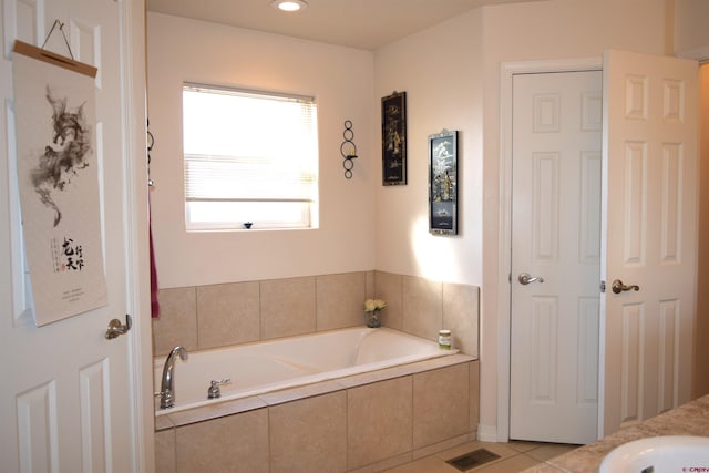 bathroom featuring tile patterned floors and tiled bath