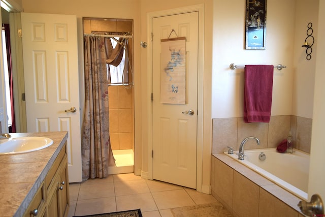 bathroom featuring independent shower and bath, vanity, and tile patterned flooring